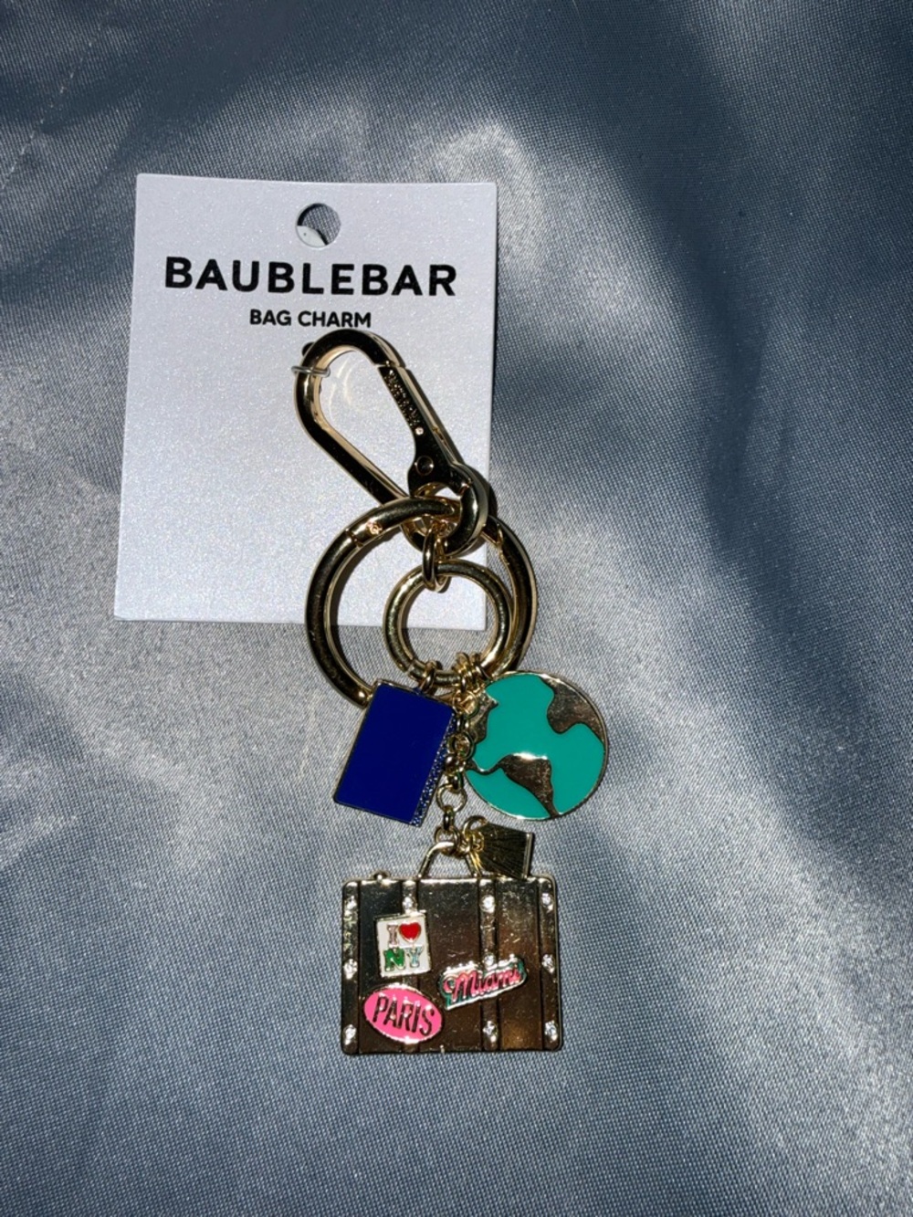 BaubleBar Gold Travel Bag Charm with Blue & Teal Accents